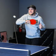 A man playing ping pong at the office