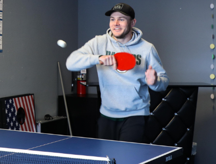 A man playing ping pong at the office