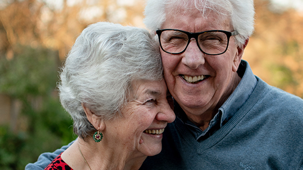 A elderly couple smiling